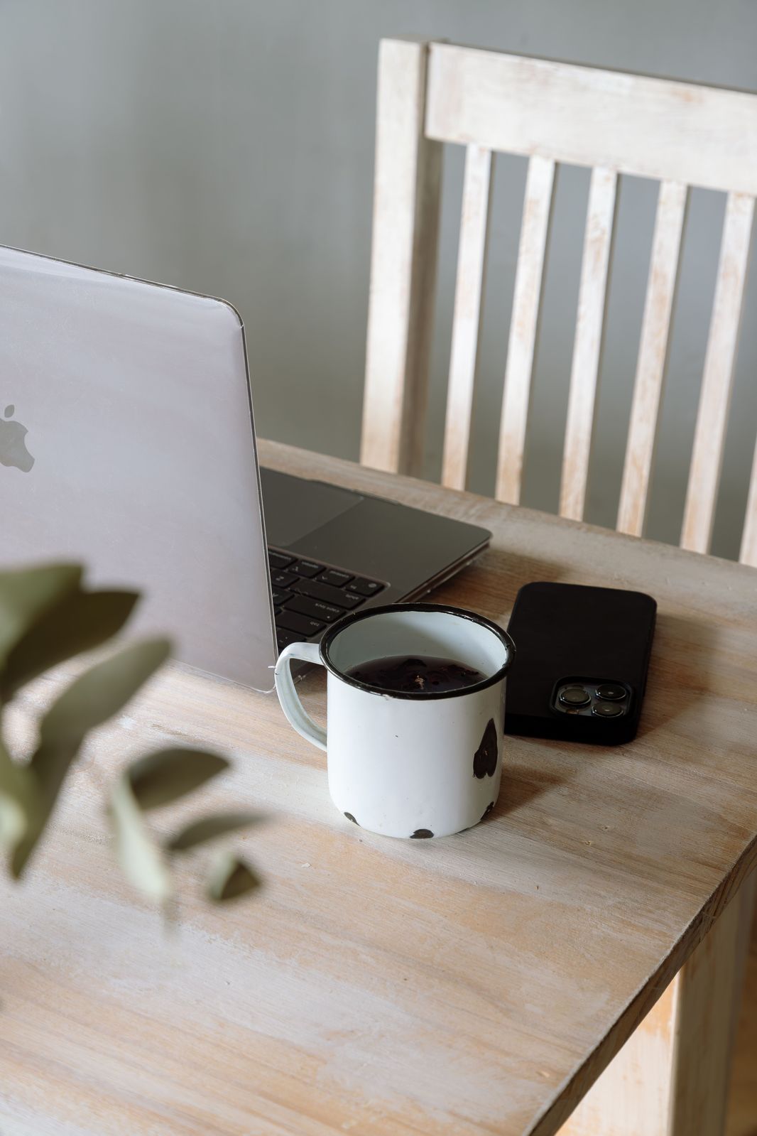 A minimal creative workspace with a laptop and coffee — everything in this field guide runs in a browser like this