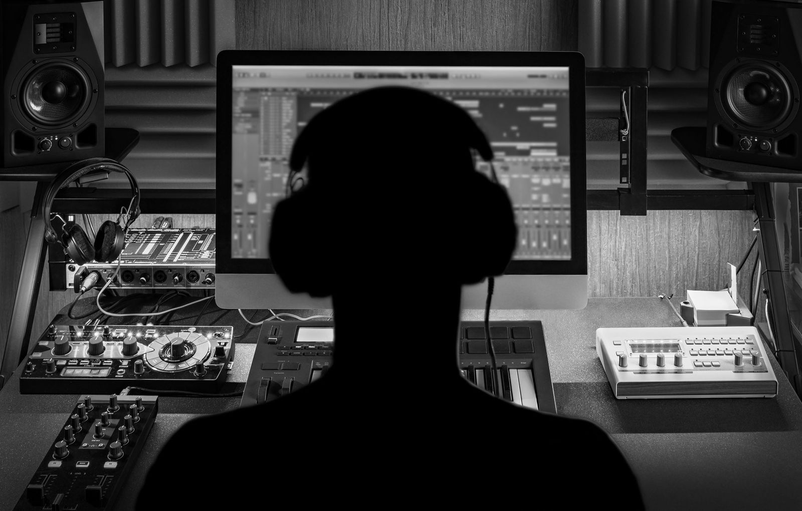 A home music studio setup with headphones and a microphone — Monyx Studio turns this into a full DAW in the browser